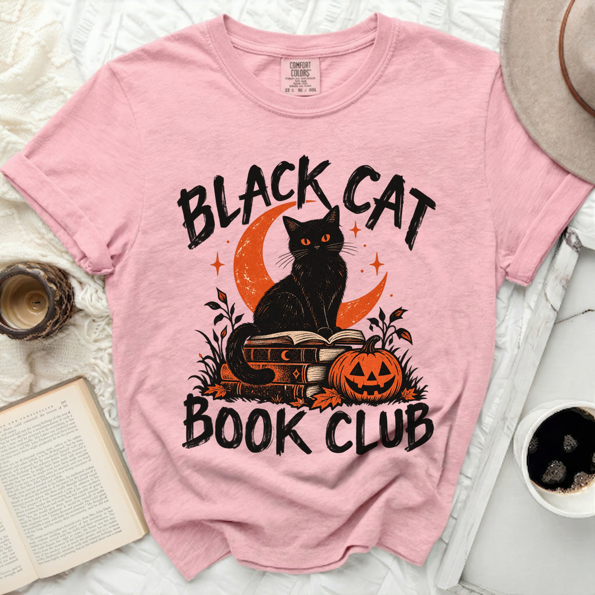 Pink t-shirt with "Black Cat Book Club" text and graphic.