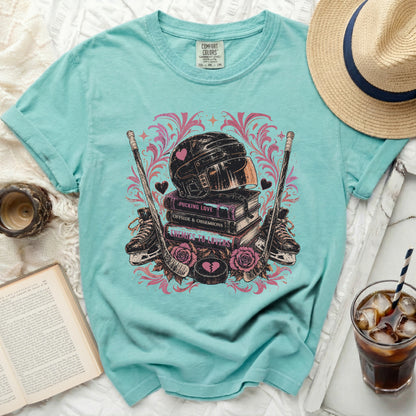 Teal t-shirt with hockey gear, books, and romantic text.