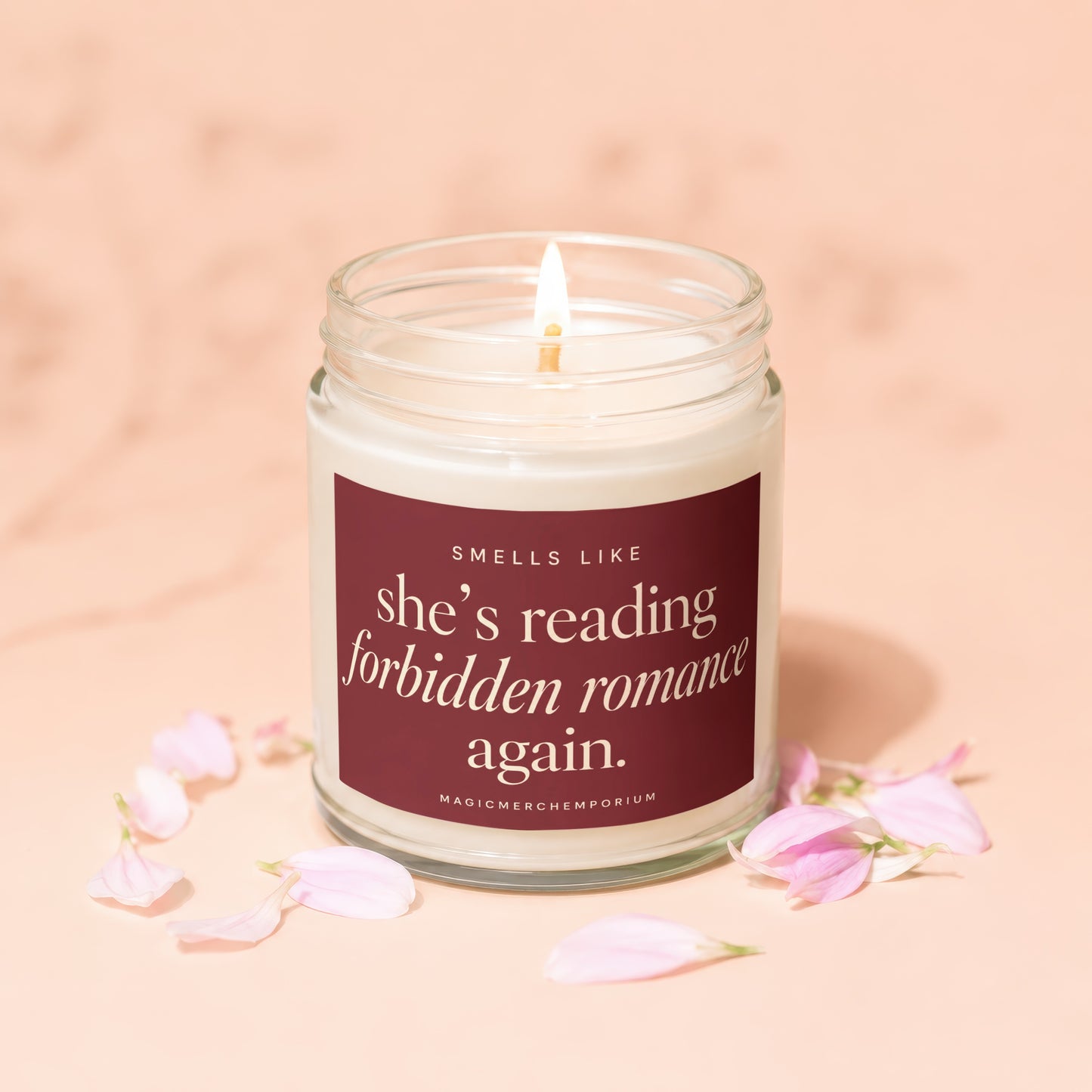 Lit candle with "Smells like she's reading forbidden romance again" text.