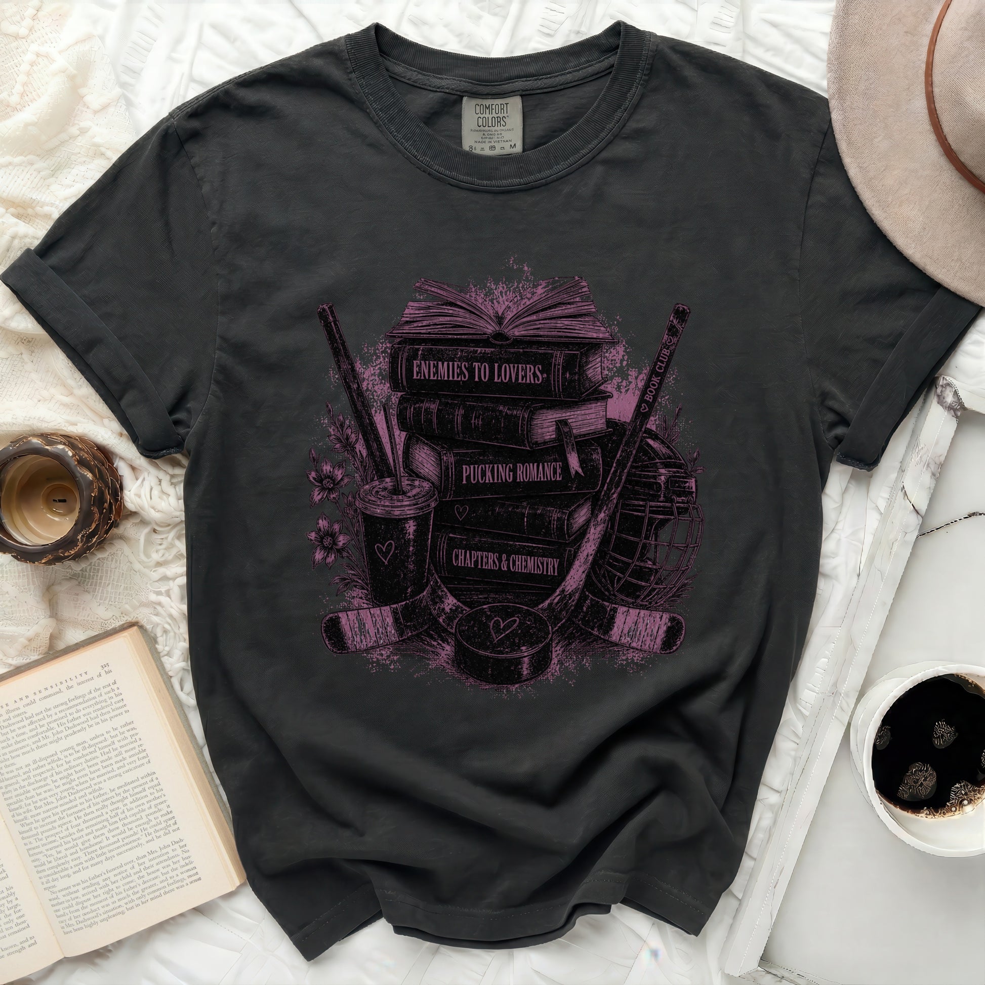 Graphic tee with stack of books, hockey stick, and puck graphic.