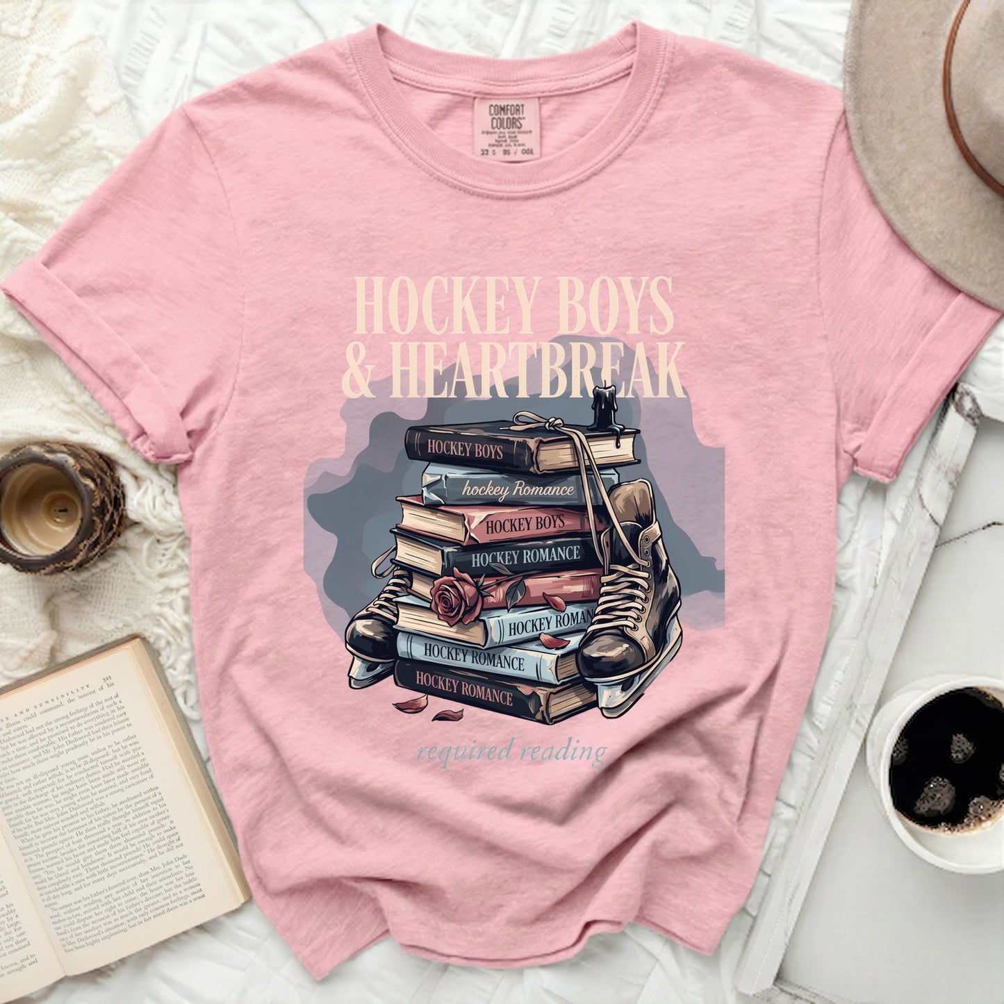 Pink t-shirt with "Hockey Boys & Heartbreak" and books with skate.