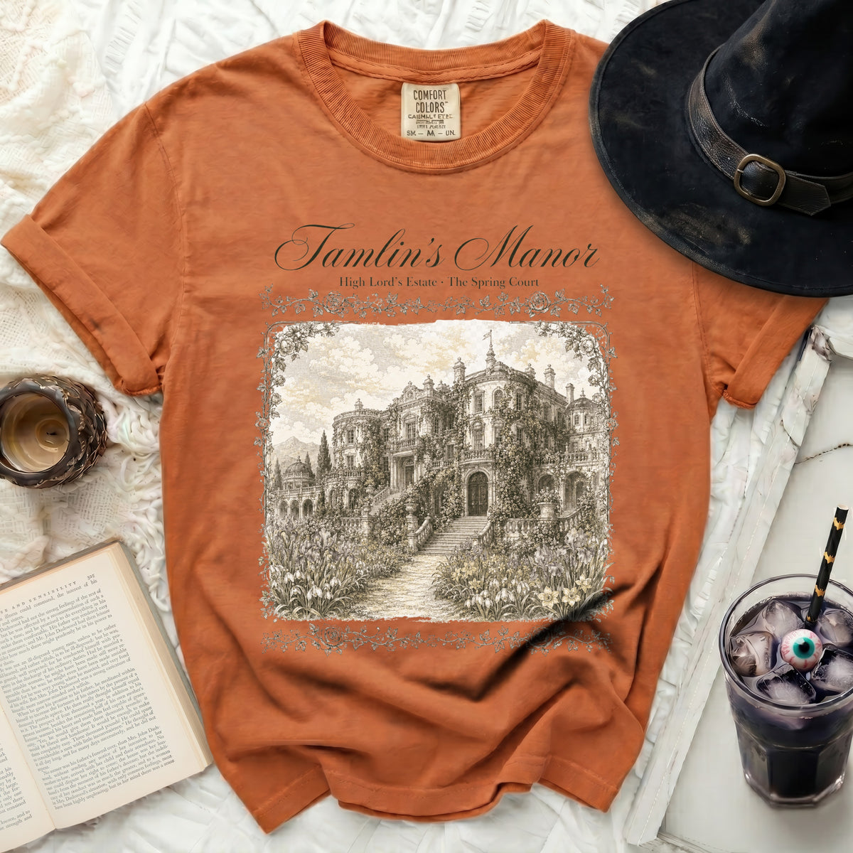 Orange t-shirt with "Tamlin's Manor High Lord's Estate The Spring Court" text and manor illustration.