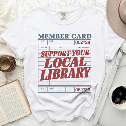 White t-shirt with "MEMBER CARD" and "SUPPORT YOUR LOCAL LIBRARY" graphic.