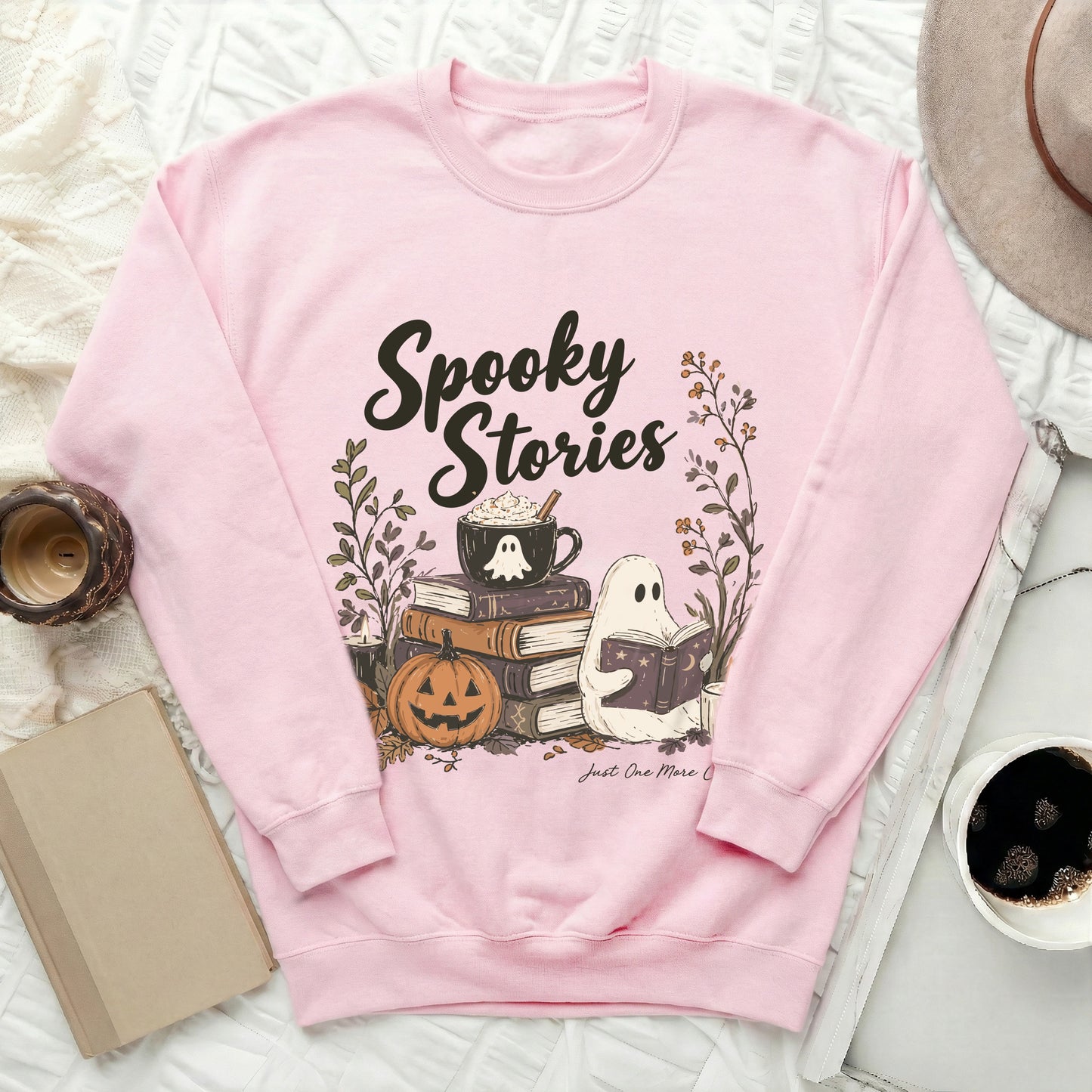 Pink sweatshirt with "Spooky Stories" text and Halloween-themed graphics.