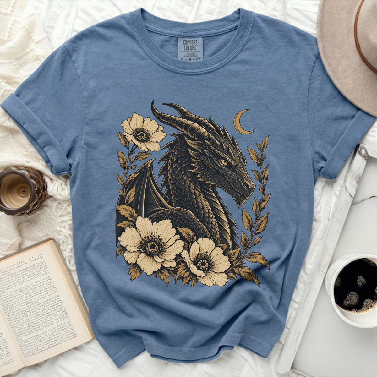 Blue t-shirt with a dark dragon and flowers graphic design, comfort colors tag.