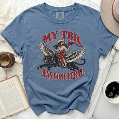 T-shirt with distressed graphic of winged panther ridden by cowgirl, "MY TBR HAS GONE FERAL".