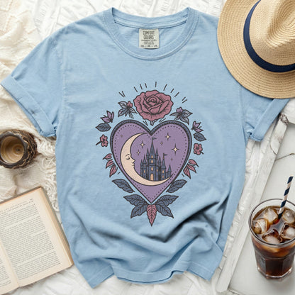 Light blue t-shirt with mystical heart, moon, and castle graphic.