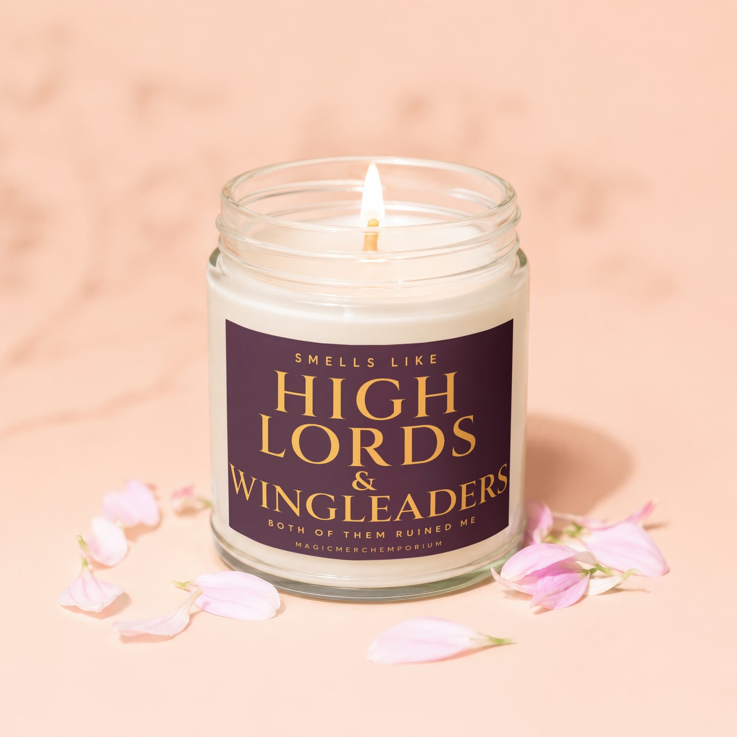 Jar candle, lit wick, with text "Smells like High Lords & Wingleaders".
