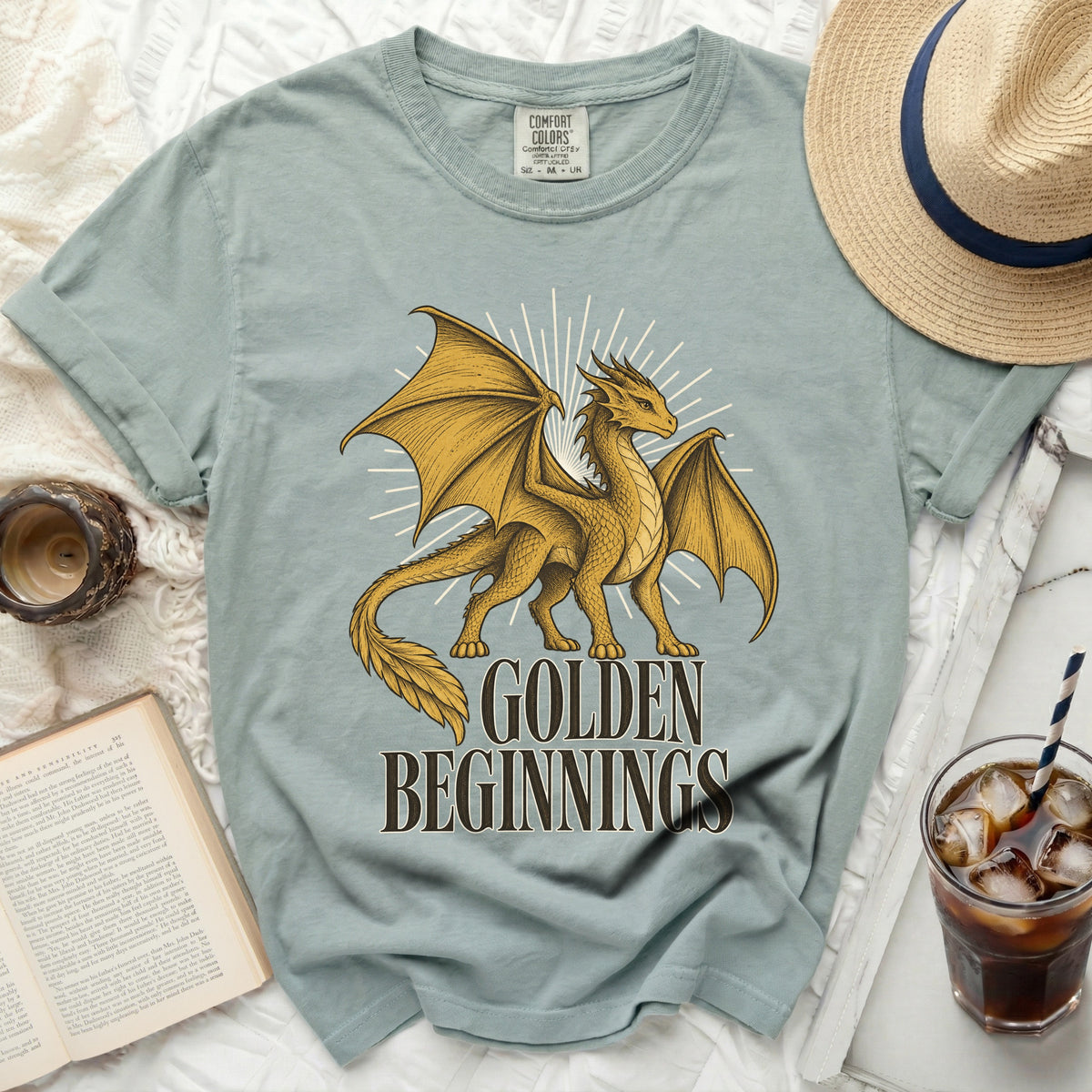 Light blue Comfort Colors t-shirt with a golden dragon and text "GOLDEN BEGINNINGS".