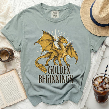 Light blue Comfort Colors t-shirt with a golden dragon and text "GOLDEN BEGINNINGS".