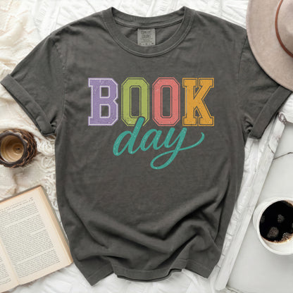 Dark gray t-shirt with "BOOK day" graphic in colorful block letters.