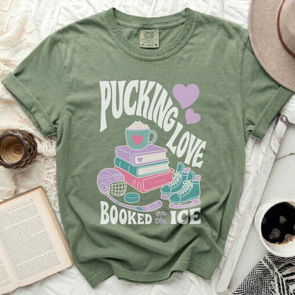 Green t-shirt with "Pucking Love Booked on the Ice" text and hockey graphics.