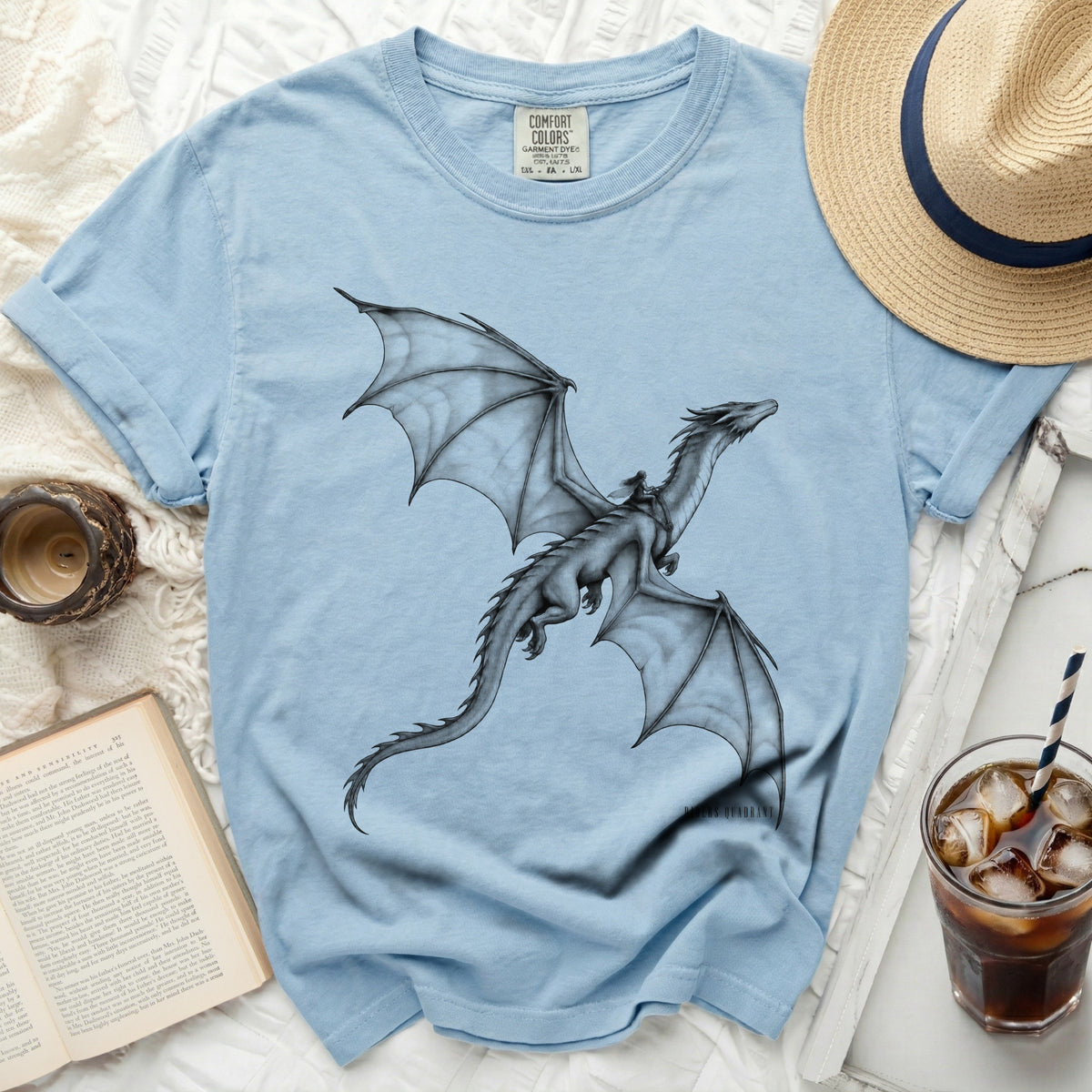 Light blue t-shirt with a black dragon graphic and rider, Comfort Colors tag visible.