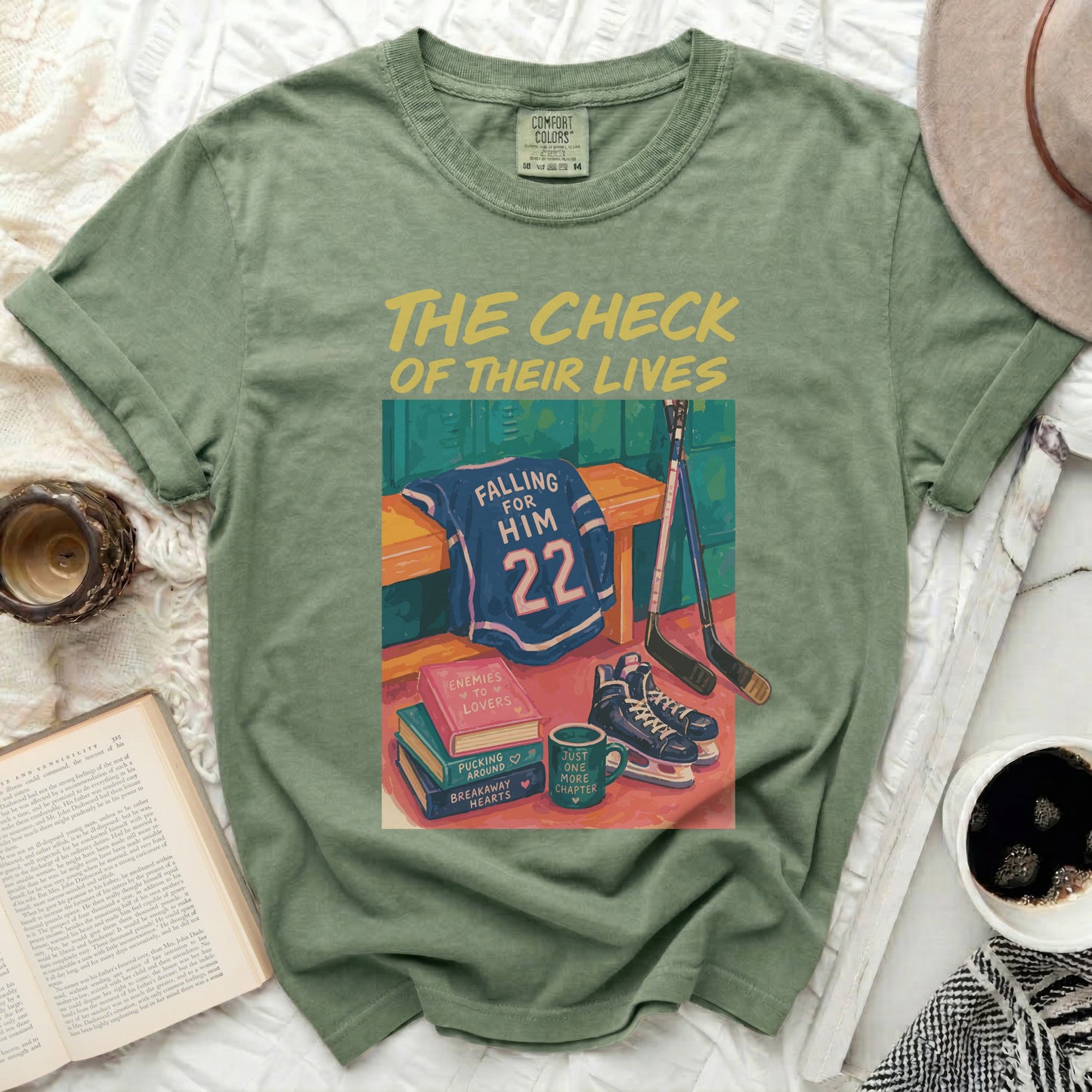 Green t-shirt with "The Check Of Their Lives" text, hockey gear, and books.