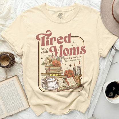 Tired Moms book club graphic with books, coffee, and candles.