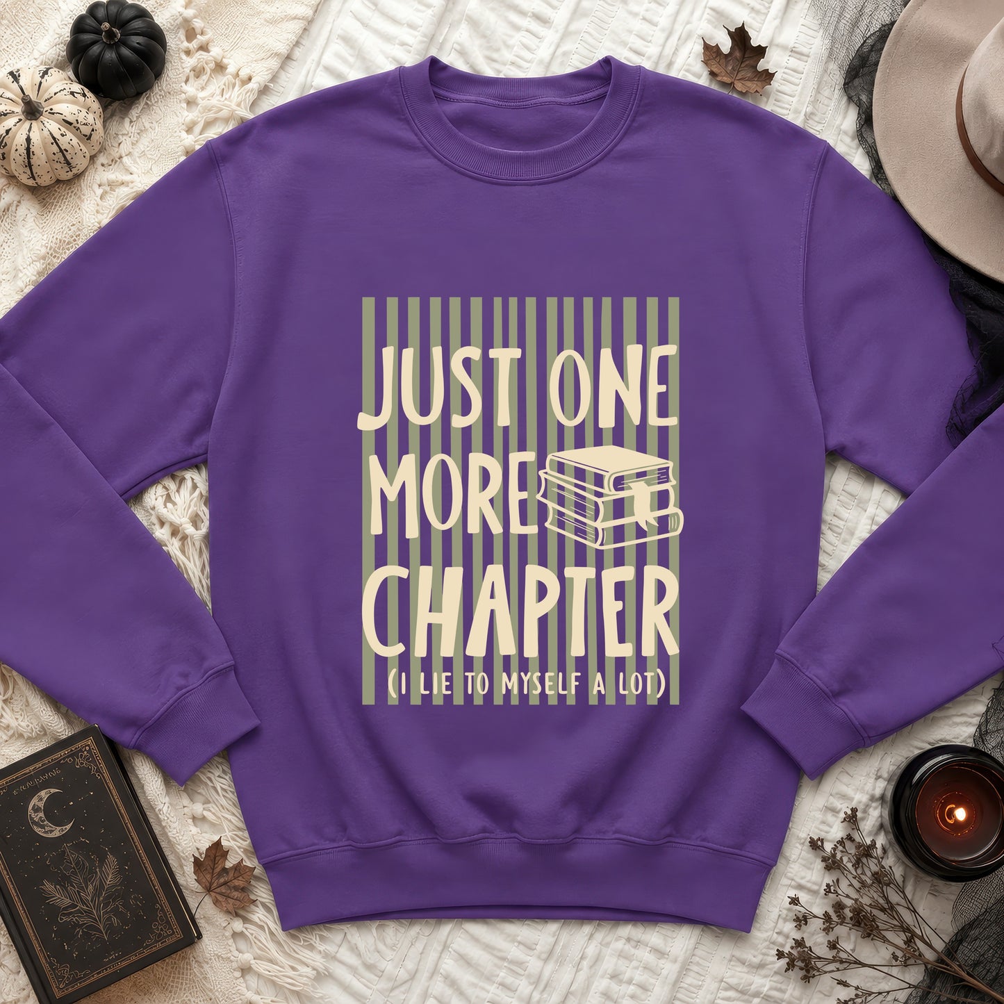 Purple sweatshirt with "Just One More Chapter (I lie to myself a lot)" text and book graphic.