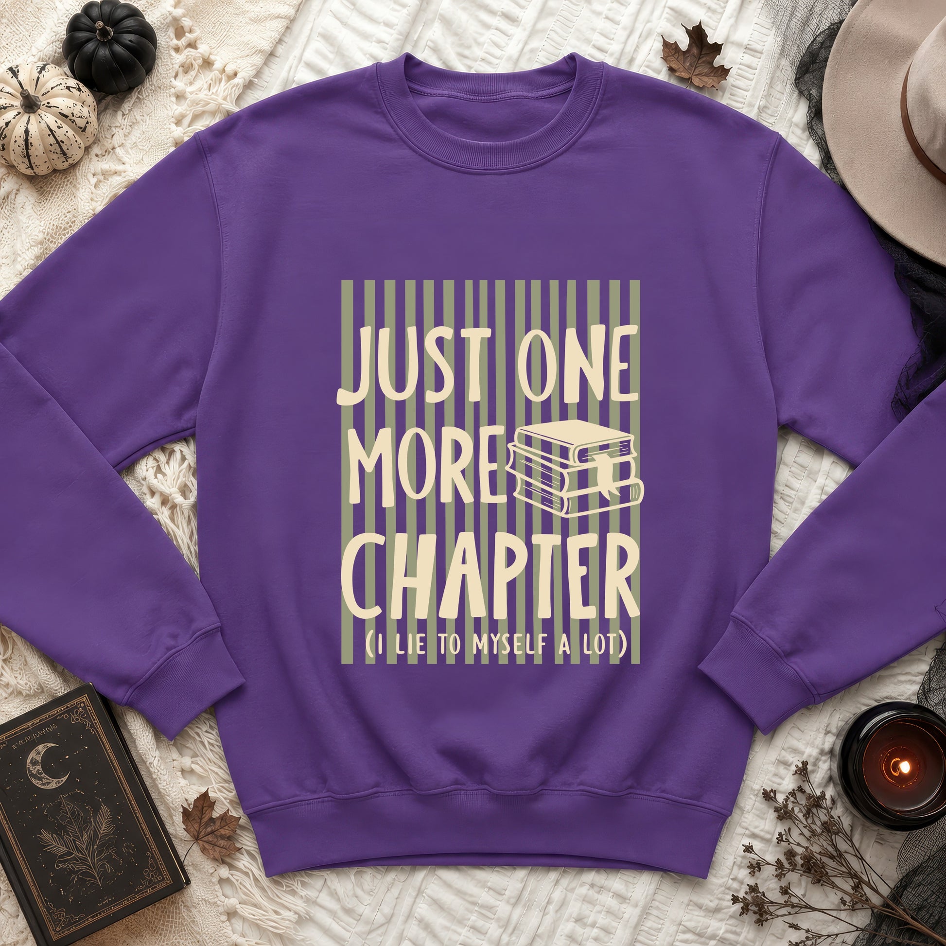 Purple sweatshirt with "Just One More Chapter (I lie to myself a lot)" text and book graphic.