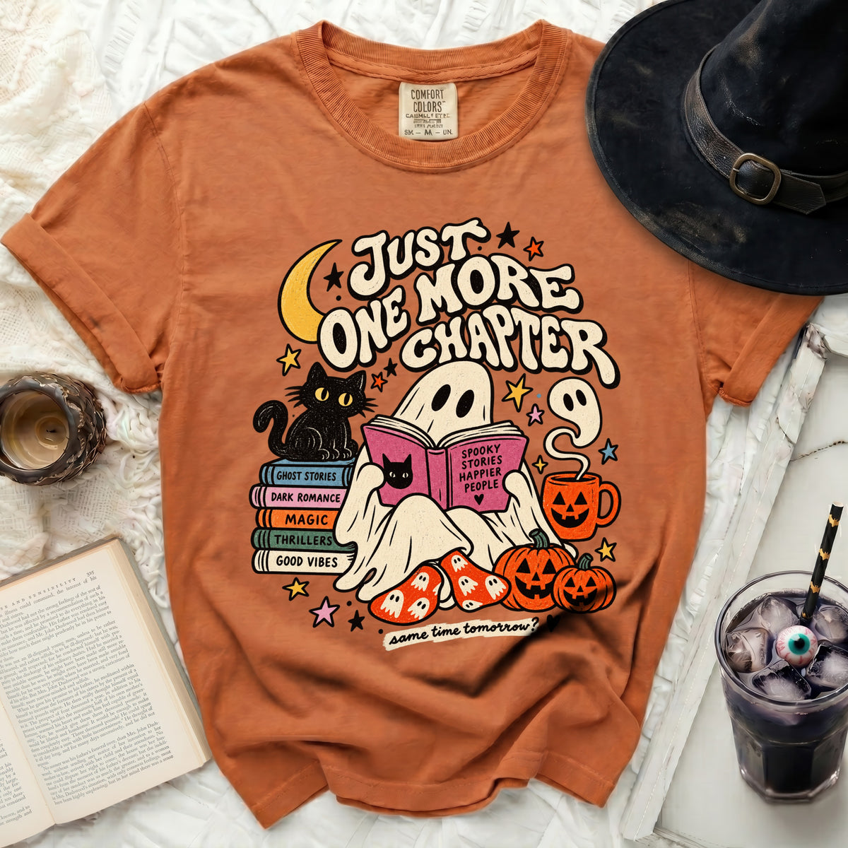 Orange t-shirt with "Just One More Chapter" ghost and book graphic.