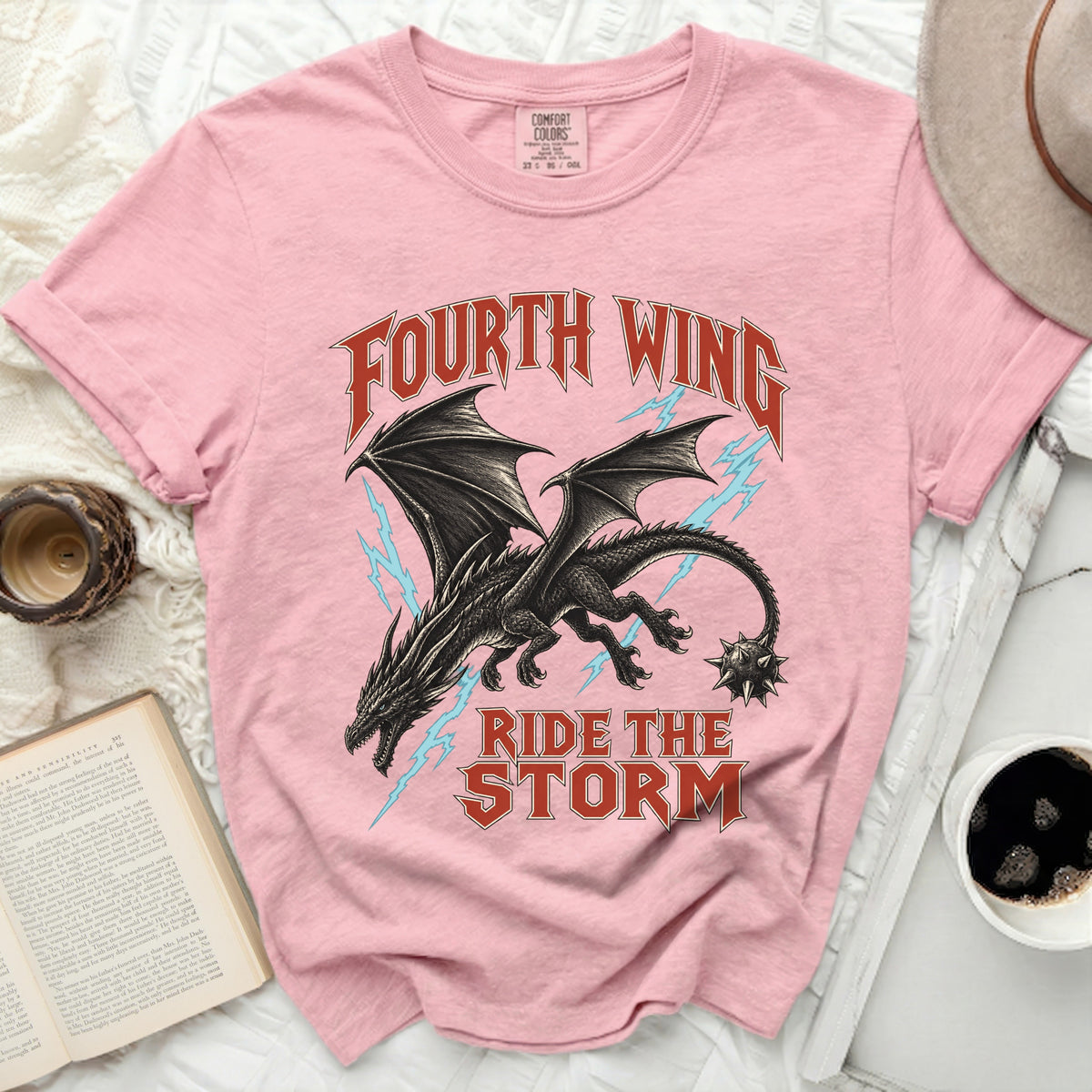 Pink t-shirt with dragon graphic and text "Fourth Wing Ride The Storm".