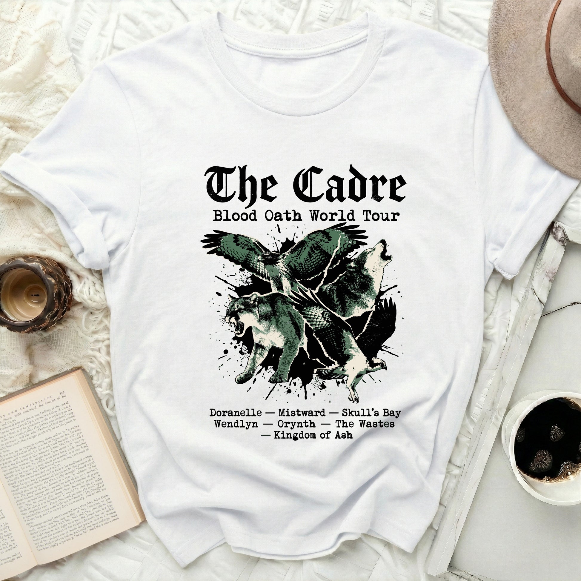 White t-shirt with "The Cadre Blood Oath World Tour" and creature graphics.