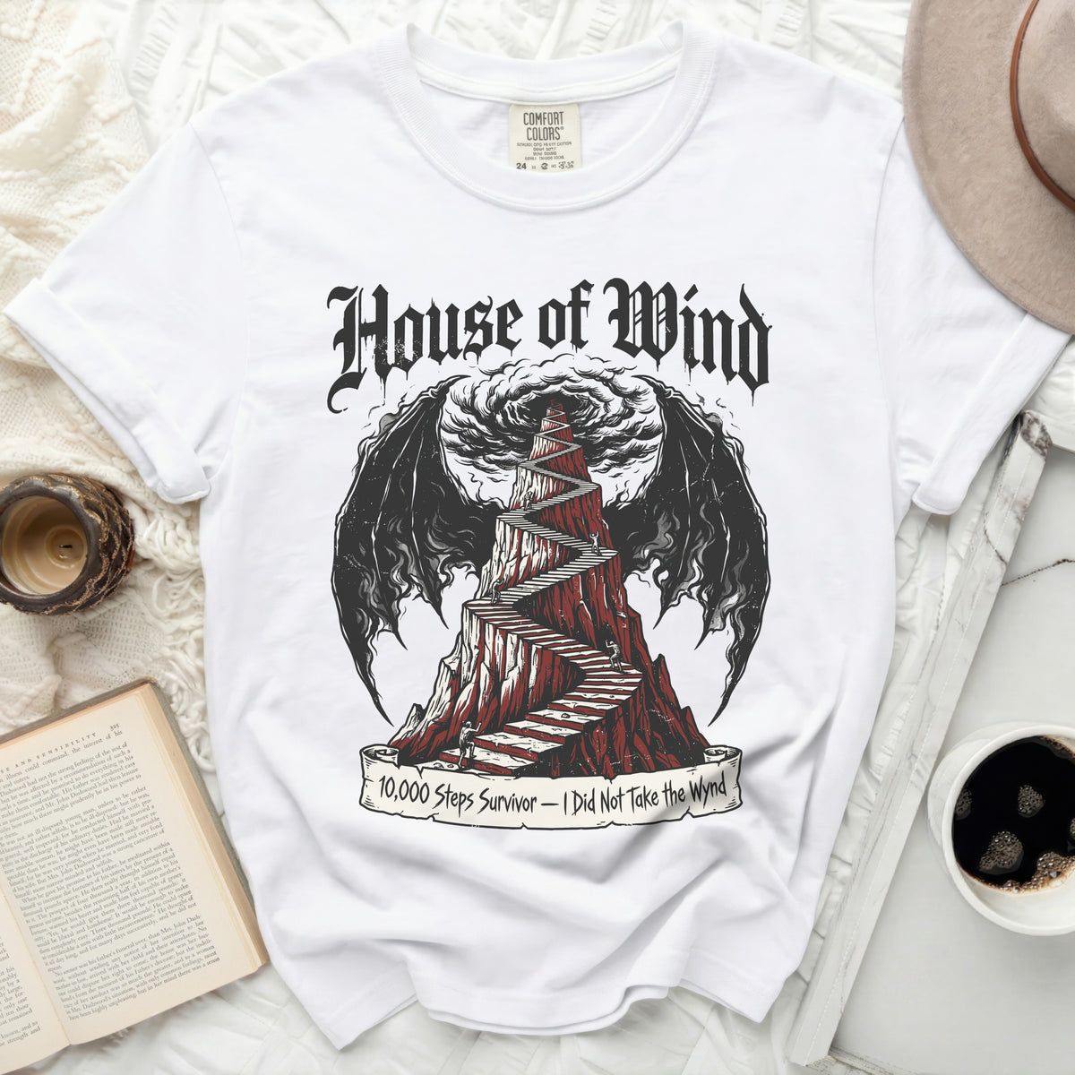 White t-shirt with "House of Wind" and staircase with wings design.