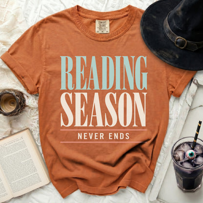 Orange t-shirt with "READING SEASON NEVER ENDS" graphic.