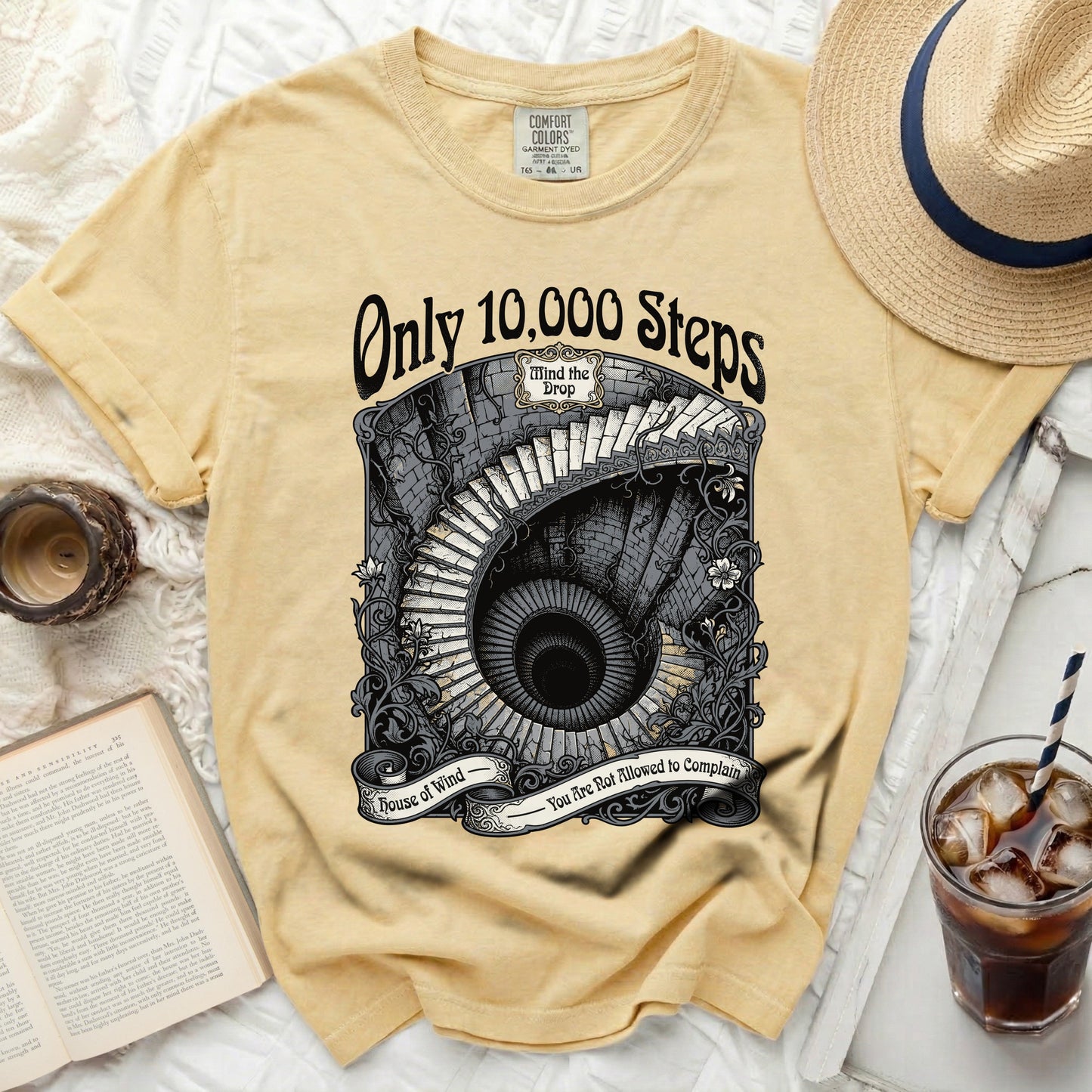 Yellow t-shirt with a circular graphic of a spiral staircase and text.