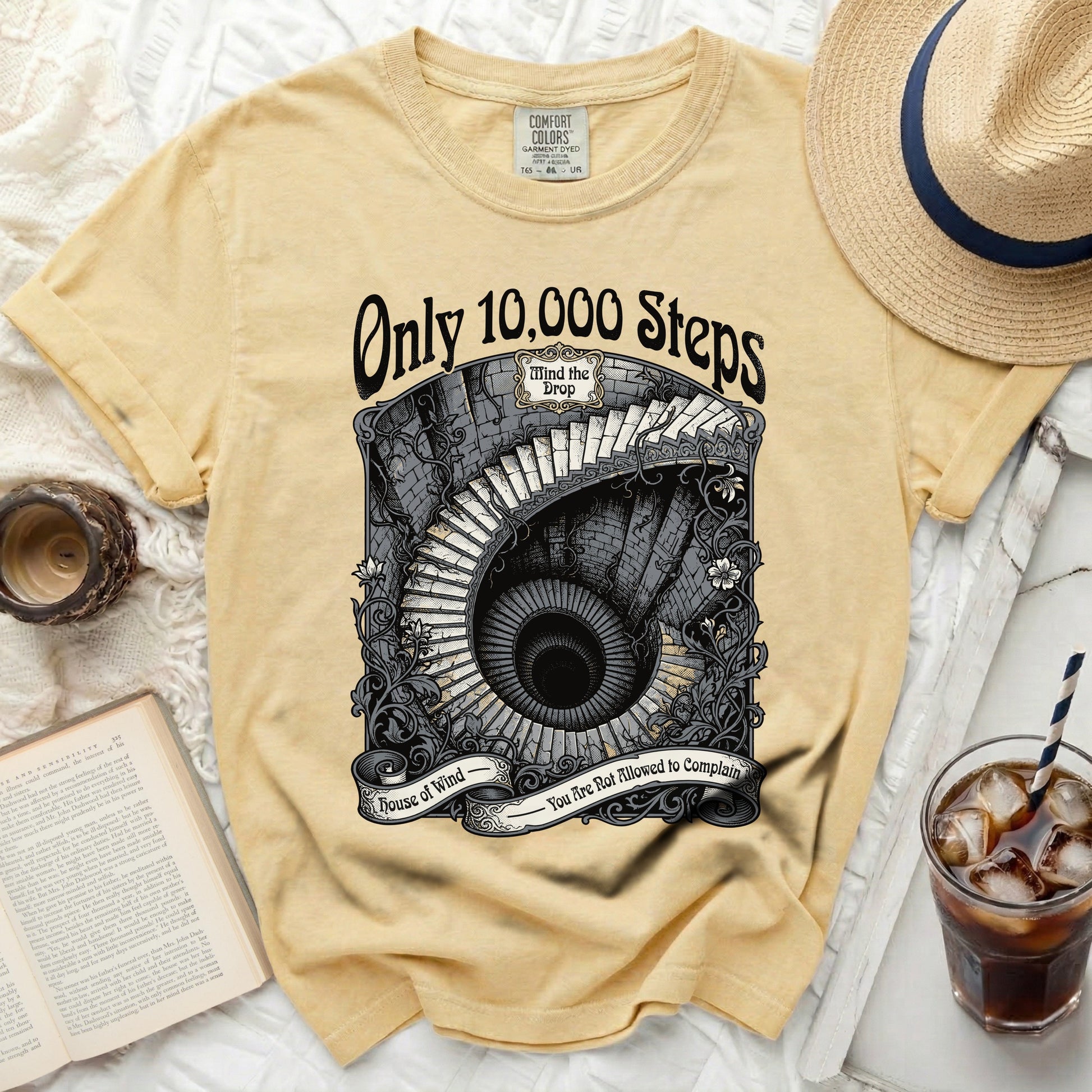 Yellow t-shirt with a circular graphic of a spiral staircase and text.