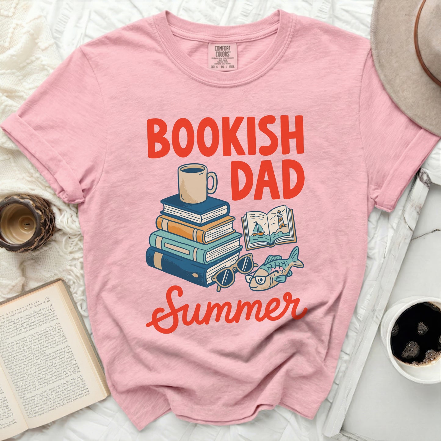 Pink t-shirt with "Bookish Dad Summer" text and stack of books.