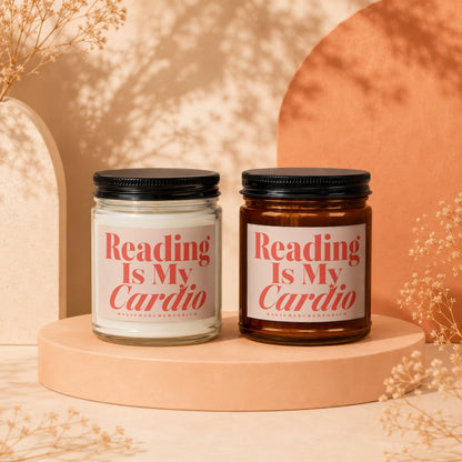 Two candles with "Reading Is My Cardio" text sit on a peach pedestal.