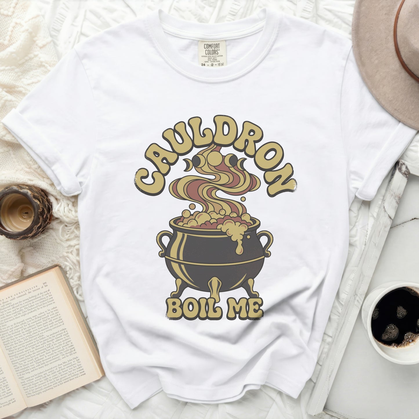 White t-shirt with "Cauldron Boil Me" graphic of a bubbling cauldron.