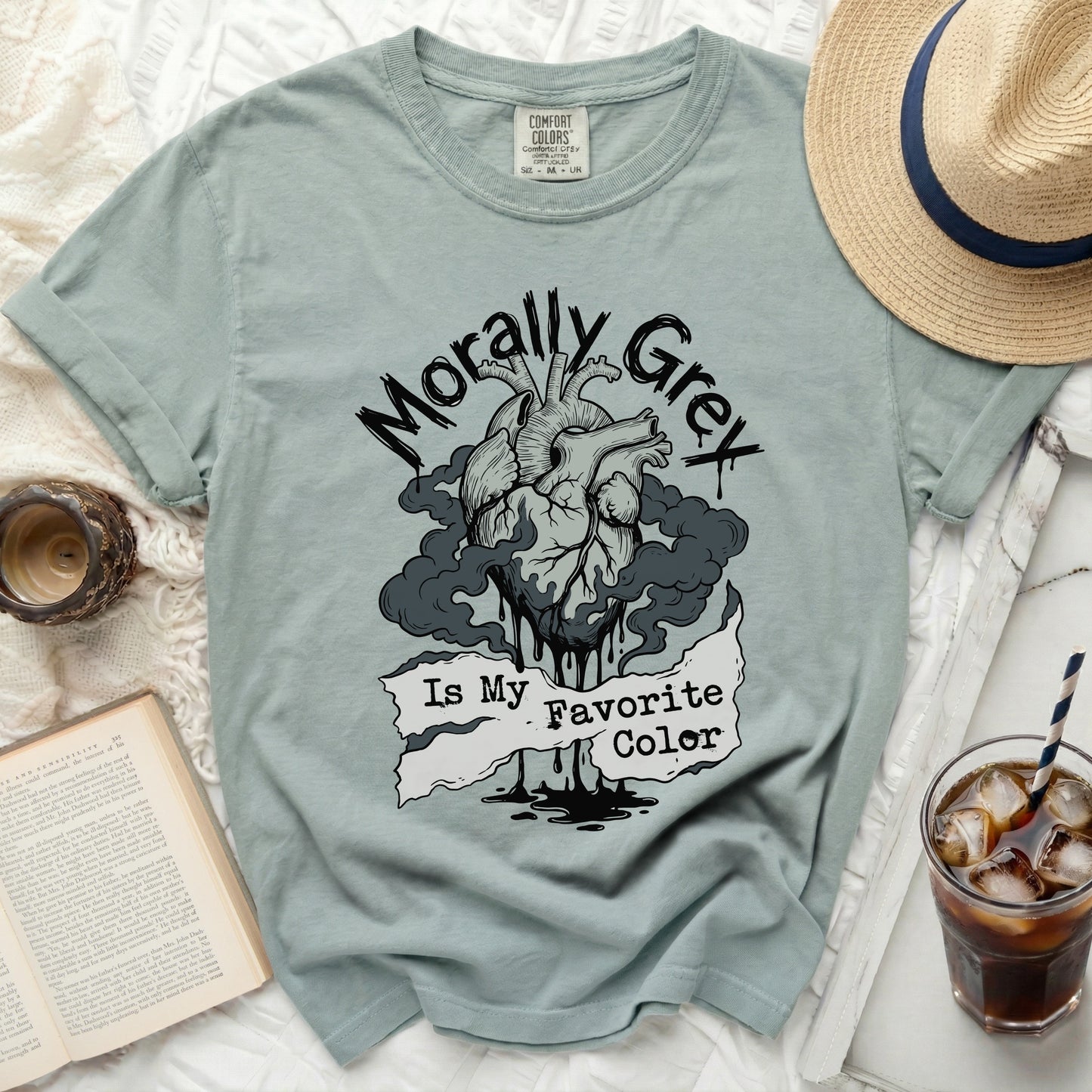Dusty blue t-shirt with a distressed anatomical heart graphic and "Morally Grey Is My Favorite Color" text.