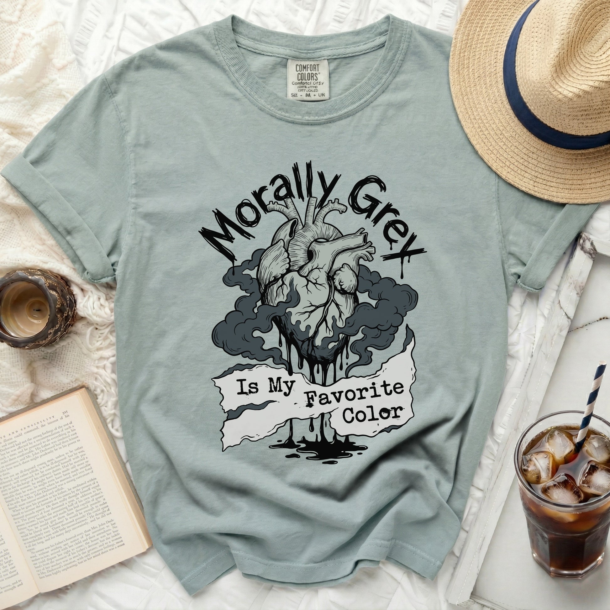 Dusty blue t-shirt with a distressed anatomical heart graphic and "Morally Grey Is My Favorite Color" text.