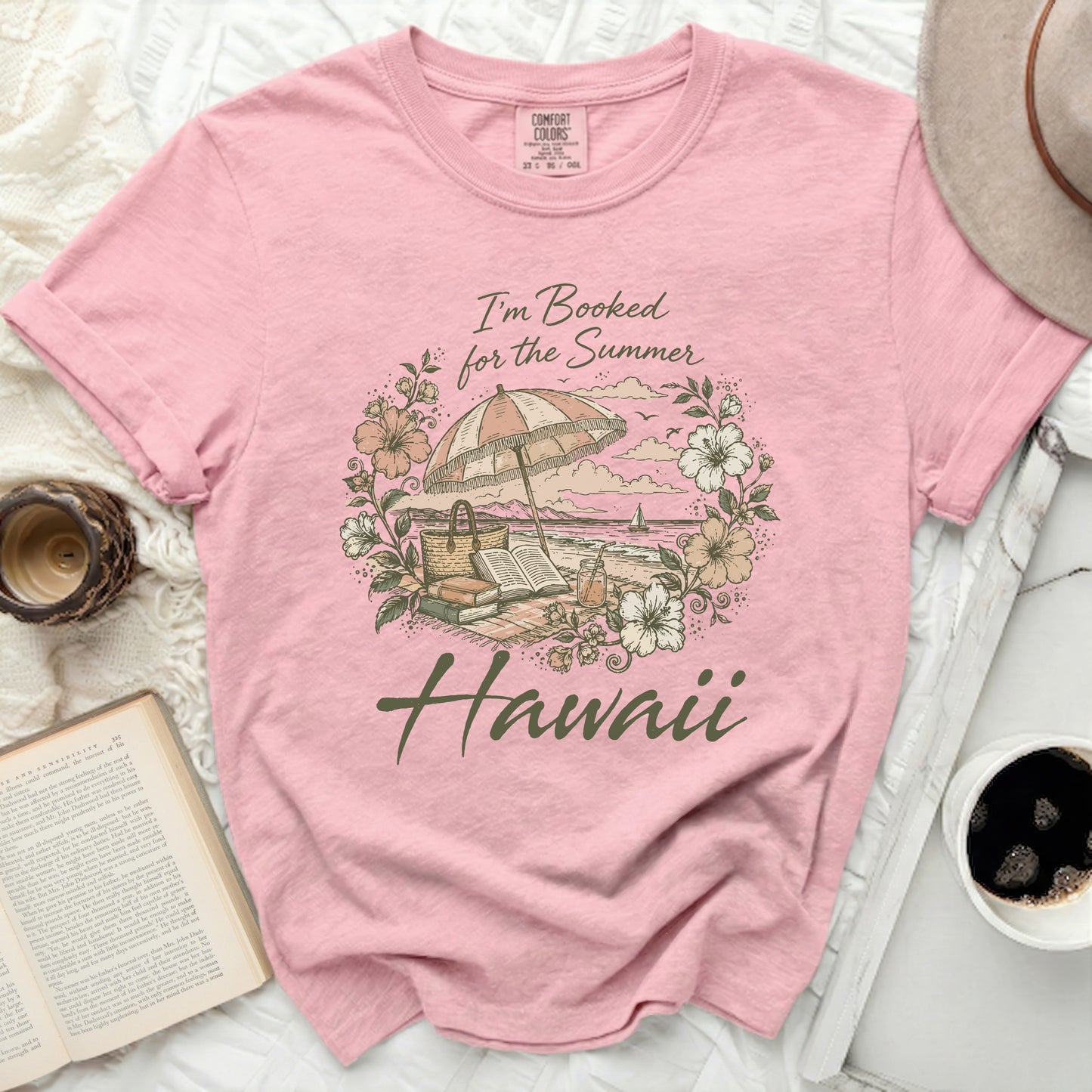 Pink t-shirt with "I'm Booked for the Summer Hawaii" and beach scene.
