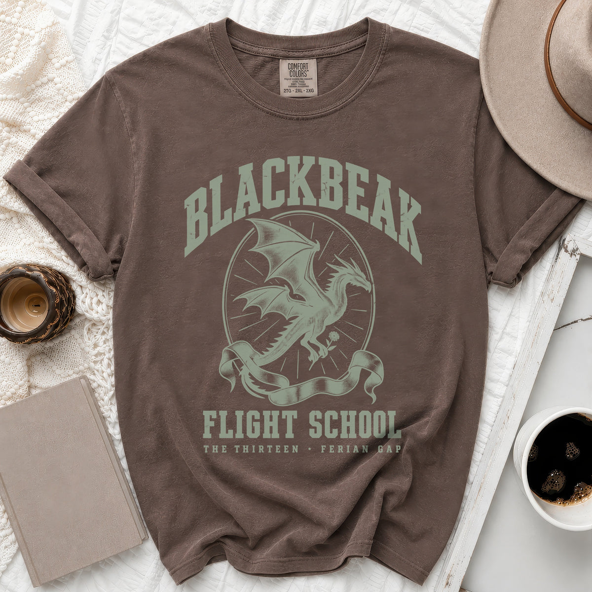 Brown crewneck t-shirt with a vintage green graphic featuring a dragon and Blackbear Flight School text.