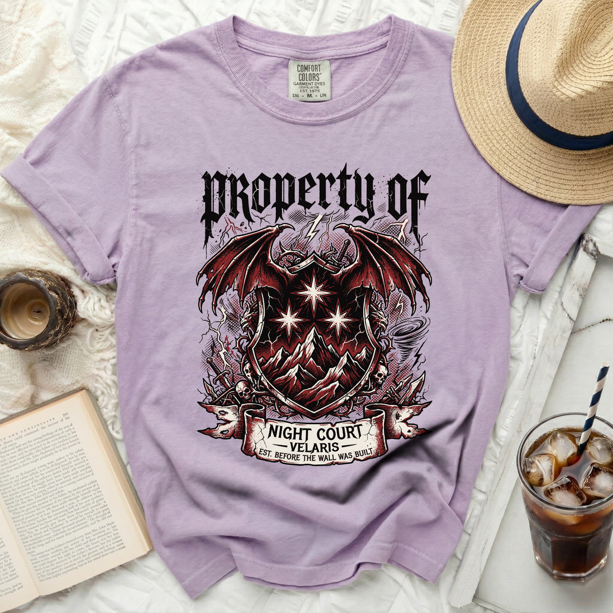 Purple t-shirt with "Property of Night Court Velaris" fantasy crest graphic.