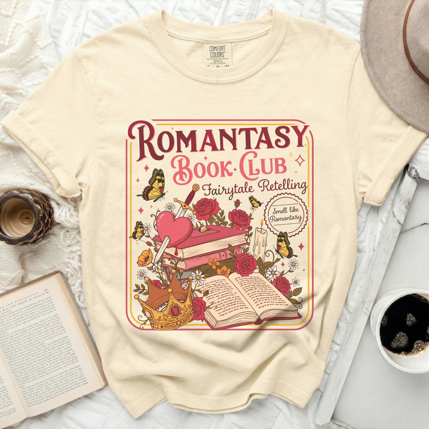 Cream t-shirt with "Romantasy Book Club" graphic featuring books, crown, and butterflies.