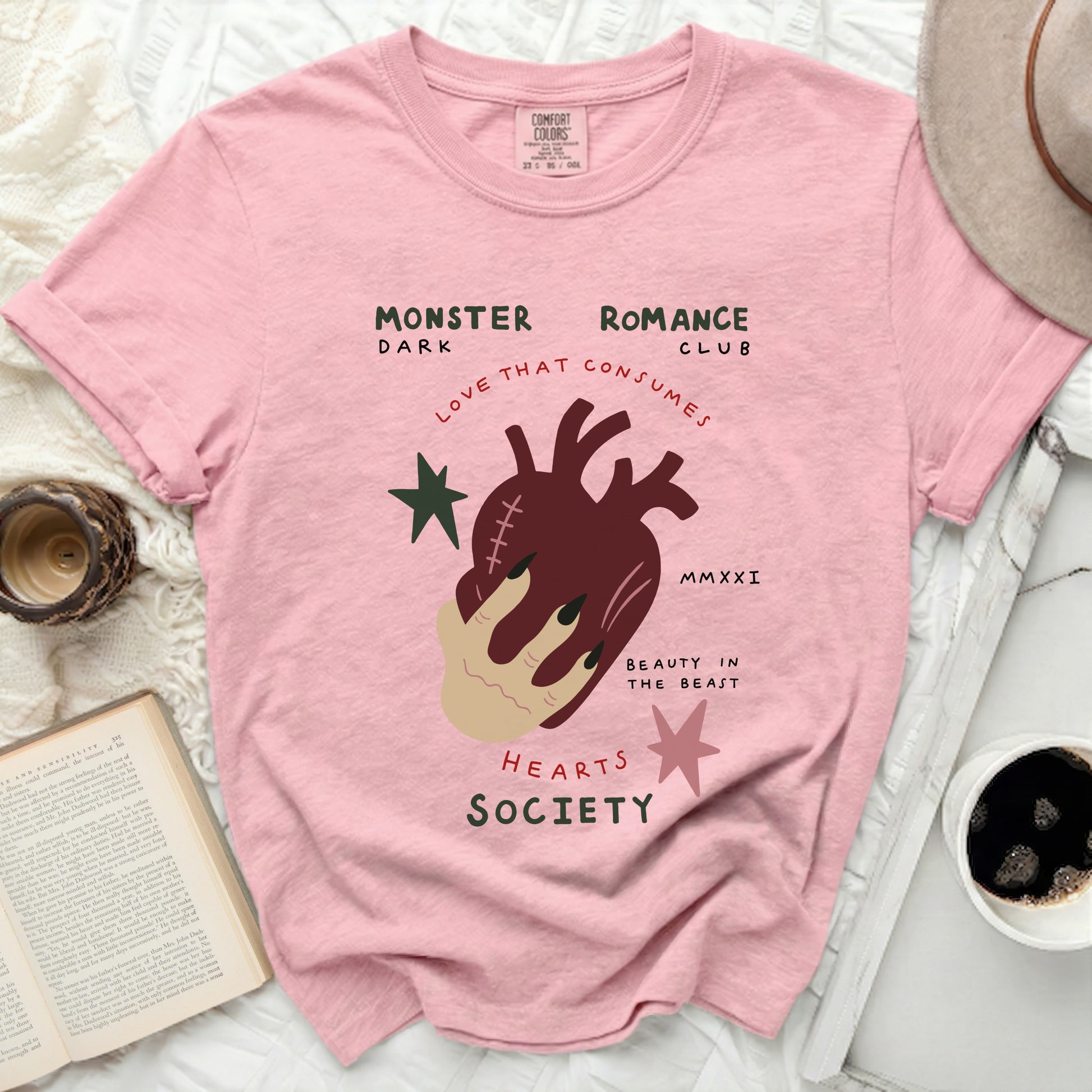 Pink t-shirt with heart, hand, and text "Monster Romance Club".