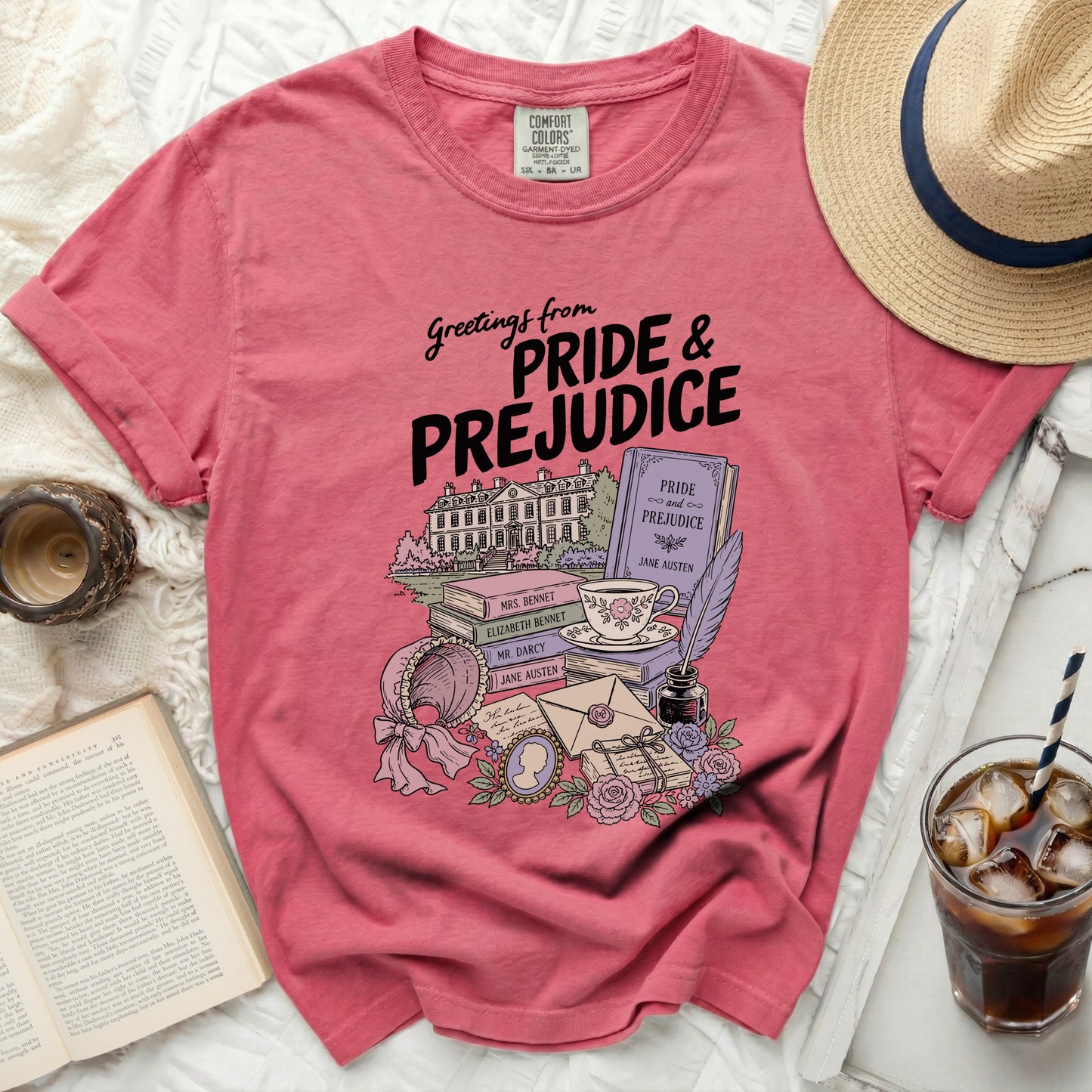 Pink t-shirt with "Greetings from Pride & Prejudice" and literary illustrations.