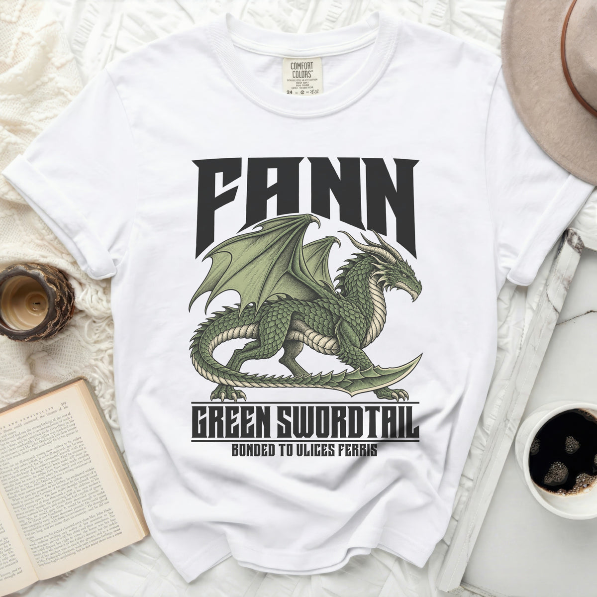 White t-shirt with a green dragon graphic and text "FANN", "GREEN SWORDTAIL", "BONDED TO ULICES FERRIS".