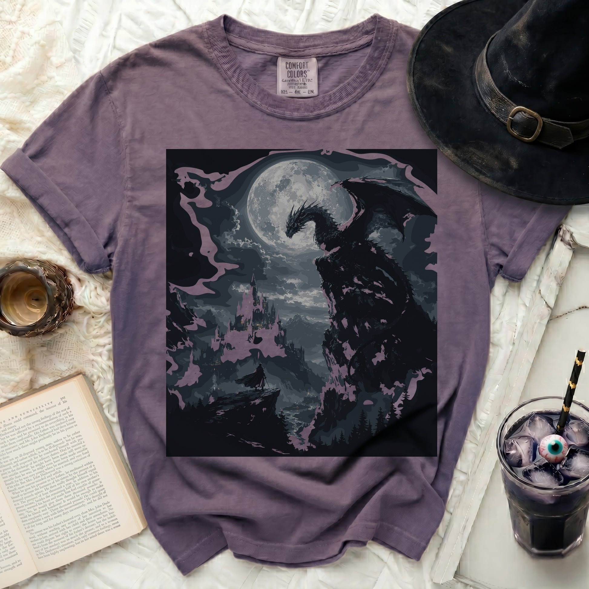 Purple t-shirt with a printed image of a dragon overlooking a castle.