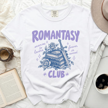 White t-shirt with "Romantasy Club" graphic of books, sword, and rose.