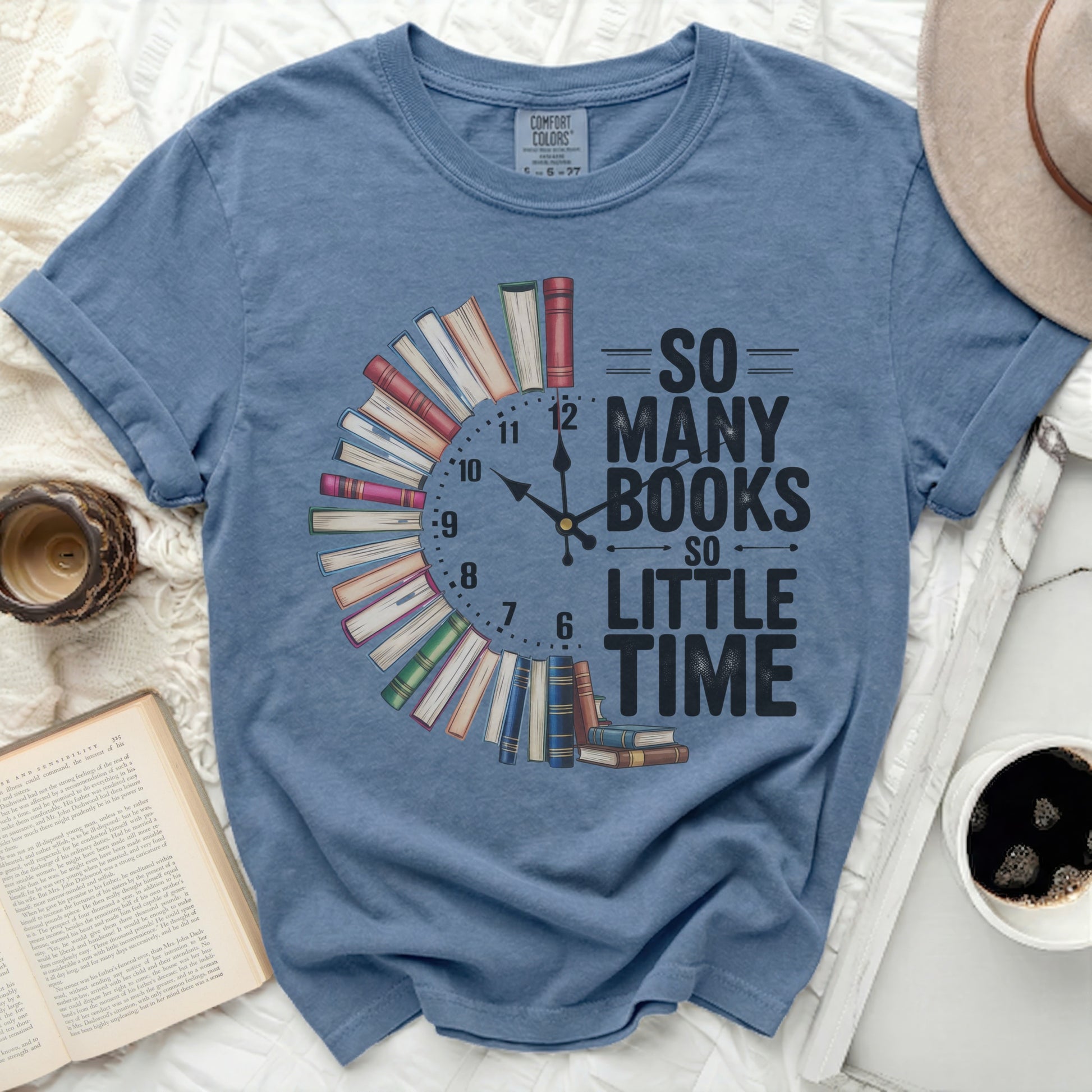 Blue t-shirt with "So Many Books So Little Time" text and book clock graphic.