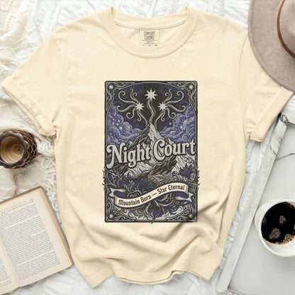 Cream t-shirt with "Night Court Mountain Born Star Eternal" text and mountain graphic.