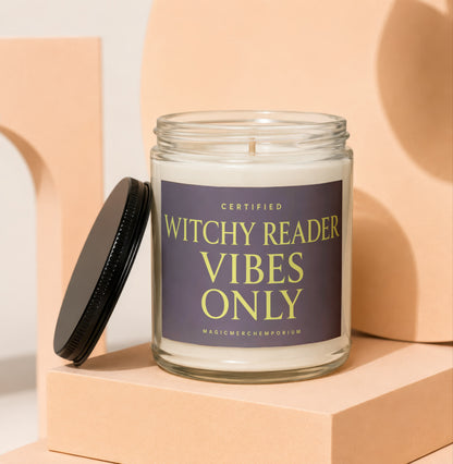 Glass candle labeled "Witchy Reader Vibes Only" with black lid off.