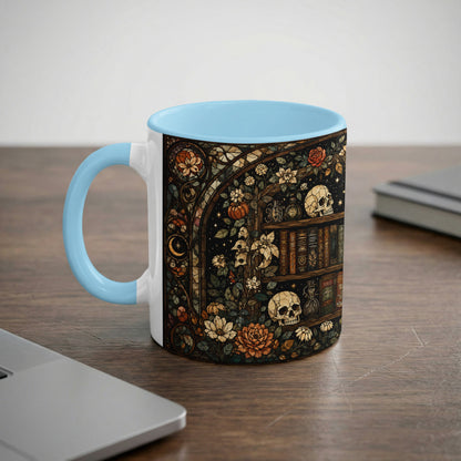 Mug with a stained-glass style print of skulls, books, flowers, and a crescent moon.