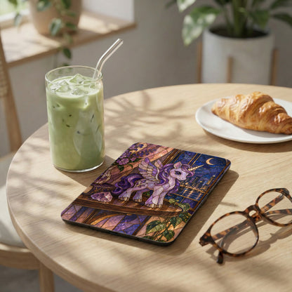 Stained glass unicorn on a case next to a matcha drink and croissant.