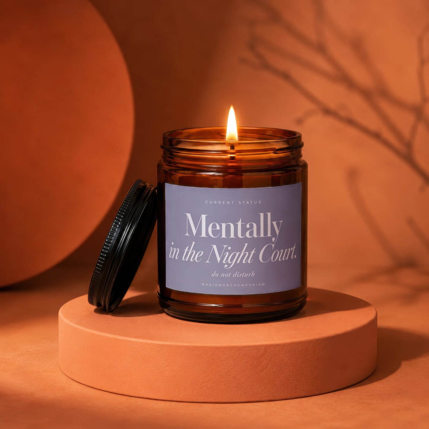 Amber jar candle with lit wick, labeled "Mentally in the Night Court. do not disturb."