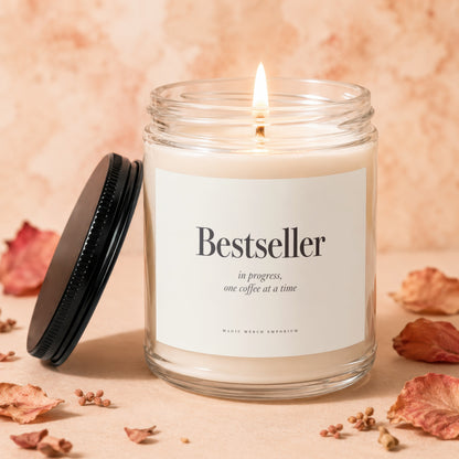 Glass candle with lit wick, "Bestseller in progress, one coffee at a time" text.