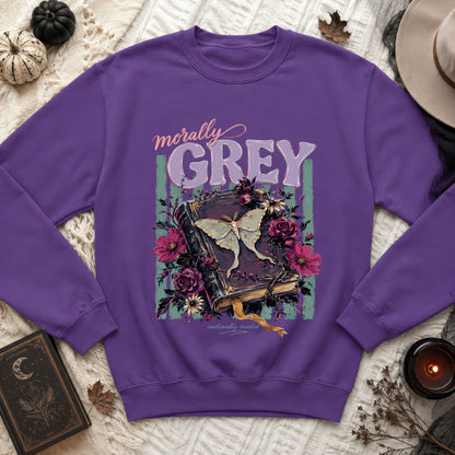 Purple sweatshirt with "Morally Grey" and moth on a book with flowers.